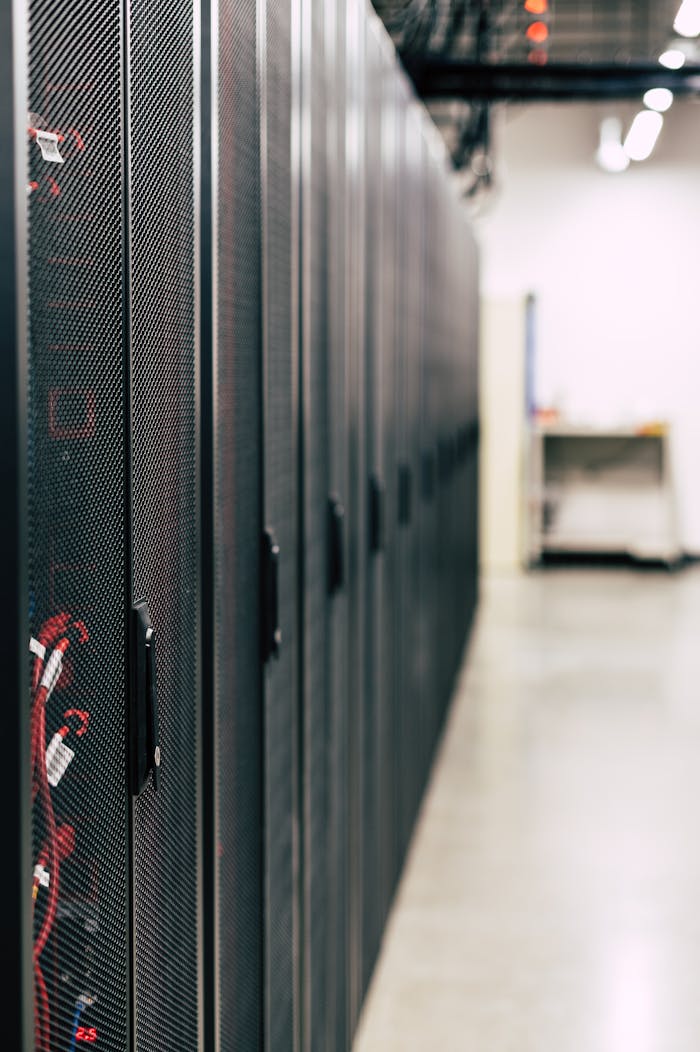 Crafting Captivating Headlines: Your awesome post title goes here Metal black cabinets with servers inside with red wires connected standing in row in lighted room